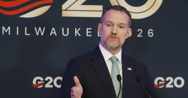 A man in a suit and tie is giving a speech at the G20 event in Milwaukee, 2026.