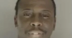 The image appears to be a close-up of a person's face, possibly for identification or news purposes.