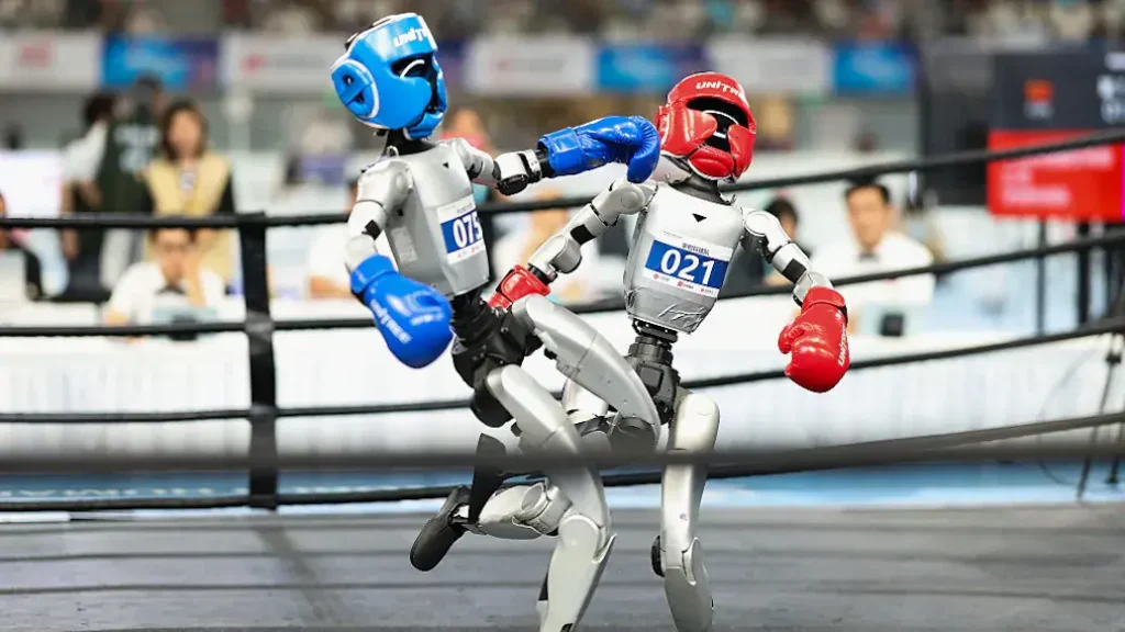 Two robots are engaged in a boxing match in a ring, showcasing advanced robotics technology.