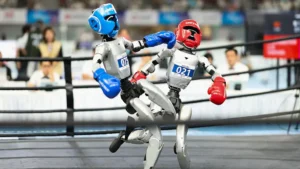 Two robots are engaged in a boxing match in a ring, showcasing advanced robotics technology.