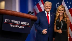 The photo shows two individuals standing in front of a podium labeled "The White House, Washington," with American flags in the background.