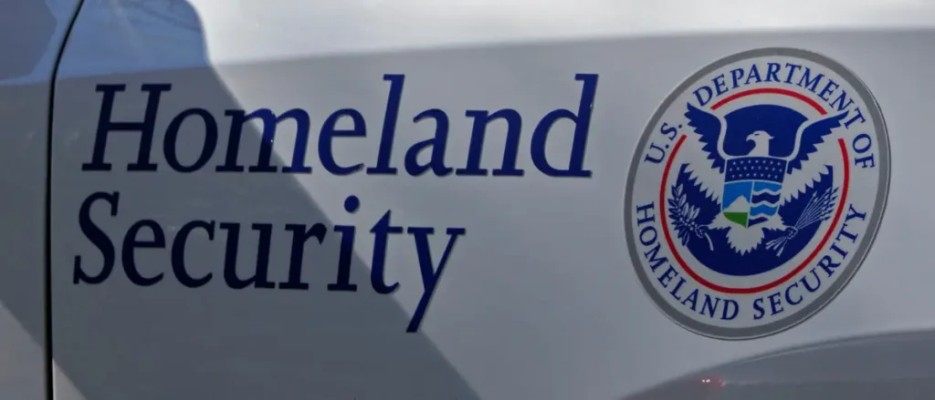 The image shows the logo of the U.S. Department of Homeland Security on a vehicle.