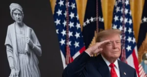 The image shows a person saluting in front of American flags and a statue of a historical figure.